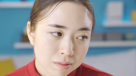 Asian-woman-looking-around-thoughtful-and-unhappy.
